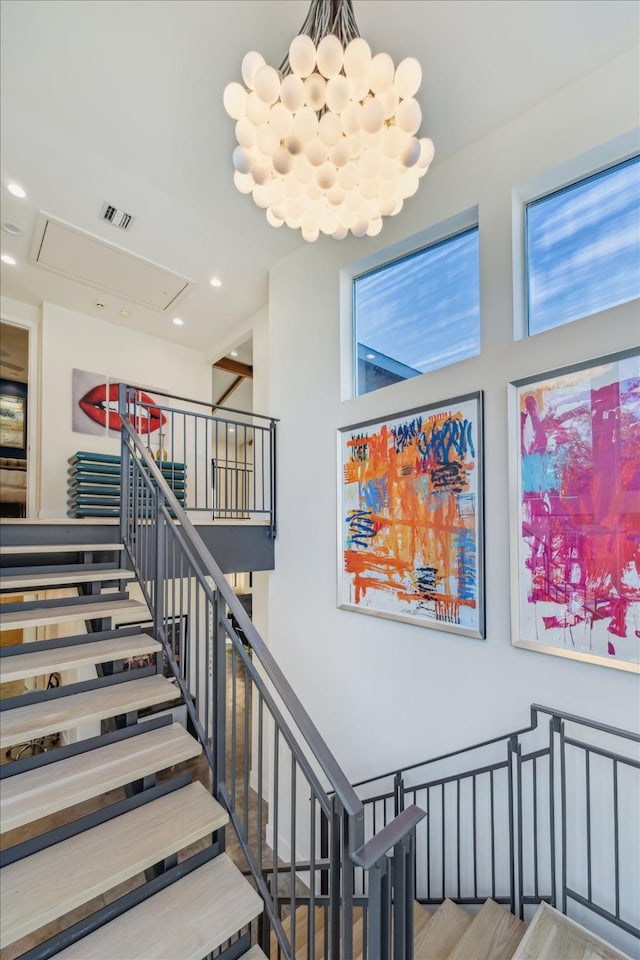 stairs with hardwood / wood-style flooring and plenty of natural light