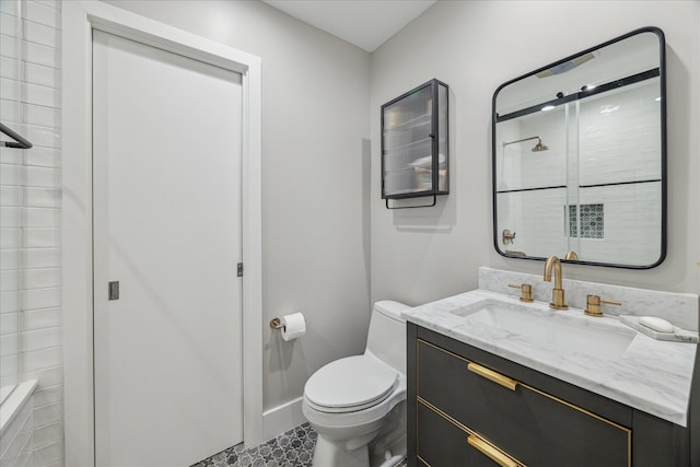 bathroom featuring vanity, a shower, and toilet