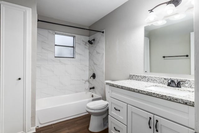 full bathroom featuring vanity, toilet, and tiled shower / bath combo