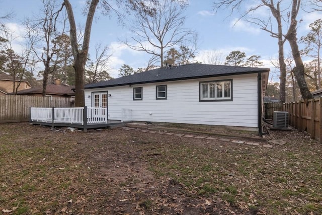 rear view of house featuring a wooden deck and central AC