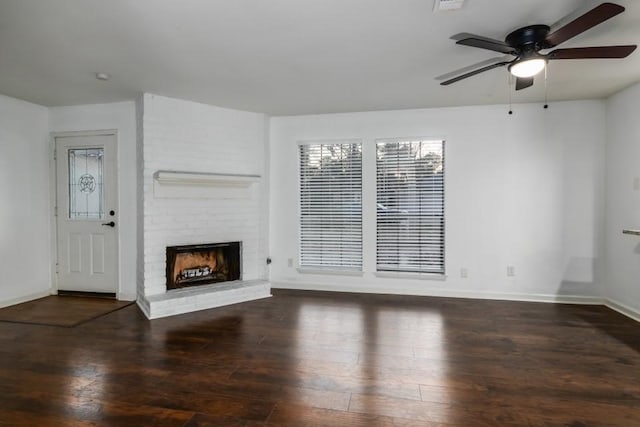 unfurnished living room with a fireplace, dark wood-type flooring, and ceiling fan