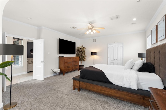 carpeted bedroom with ornamental molding and ceiling fan