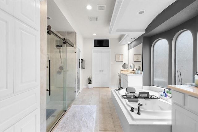 bathroom with tile patterned flooring, vanity, and plus walk in shower