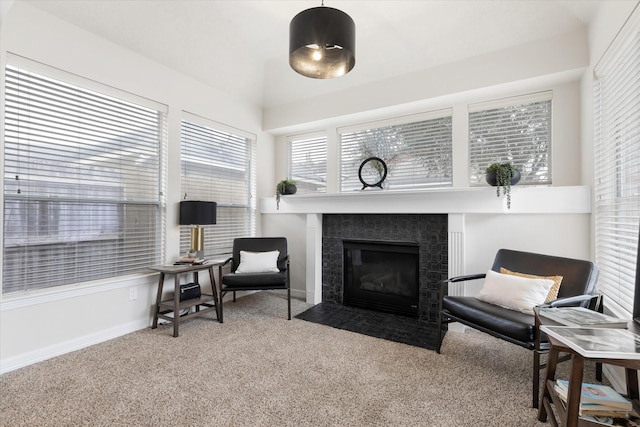 sitting room featuring light carpet and a fireplace