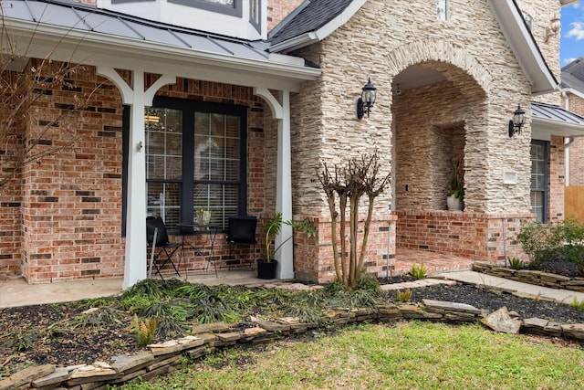 view of exterior entry with covered porch