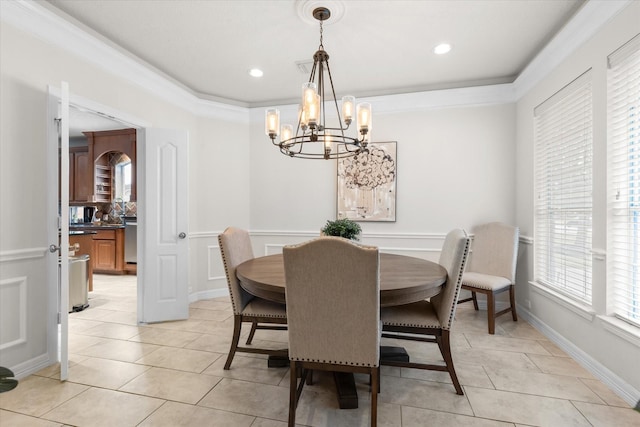 dining area with light tile patterned floors, crown molding, and a notable chandelier