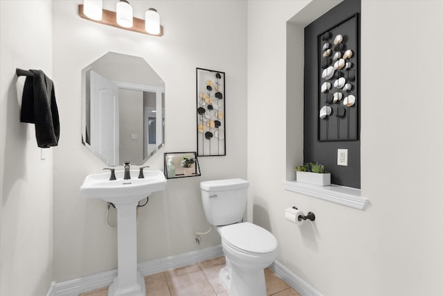 bathroom featuring tile patterned floors, toilet, and sink