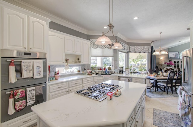 kitchen featuring white cabinetry, crown molding, decorative light fixtures, a center island, and appliances with stainless steel finishes