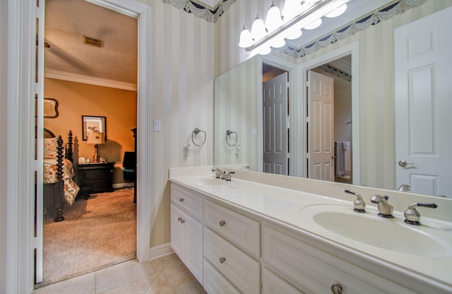 bathroom featuring crown molding, tile patterned floors, vanity, and a textured ceiling