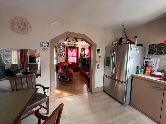 kitchen with light hardwood / wood-style floors and stainless steel fridge with ice dispenser