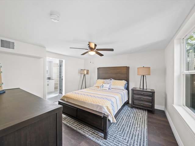 bedroom featuring dark wood-type flooring, ceiling fan, and ensuite bath