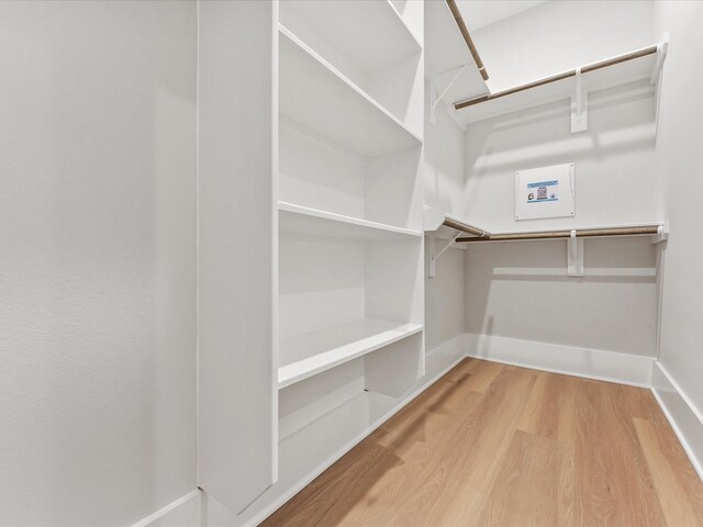 spacious closet with hardwood / wood-style floors