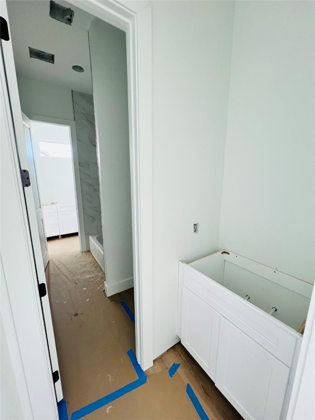 bathroom featuring hardwood / wood-style floors and a bathing tub