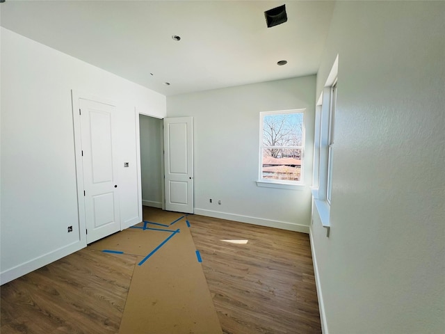 unfurnished bedroom featuring dark wood-type flooring