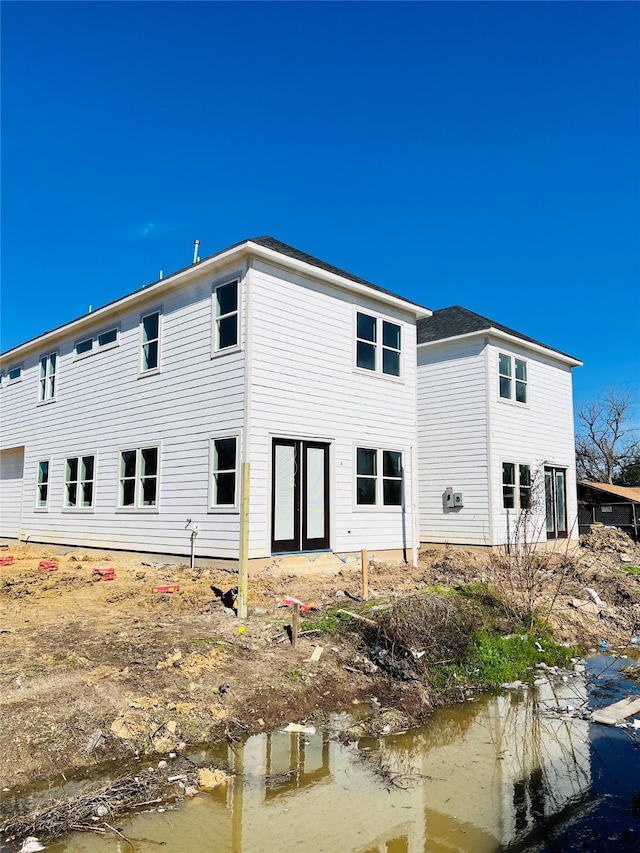 rear view of property featuring a water view