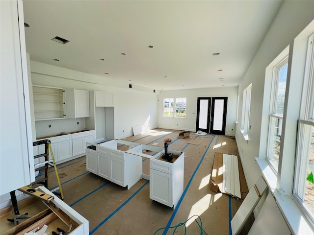 kitchen featuring french doors, white cabinets, and a kitchen island