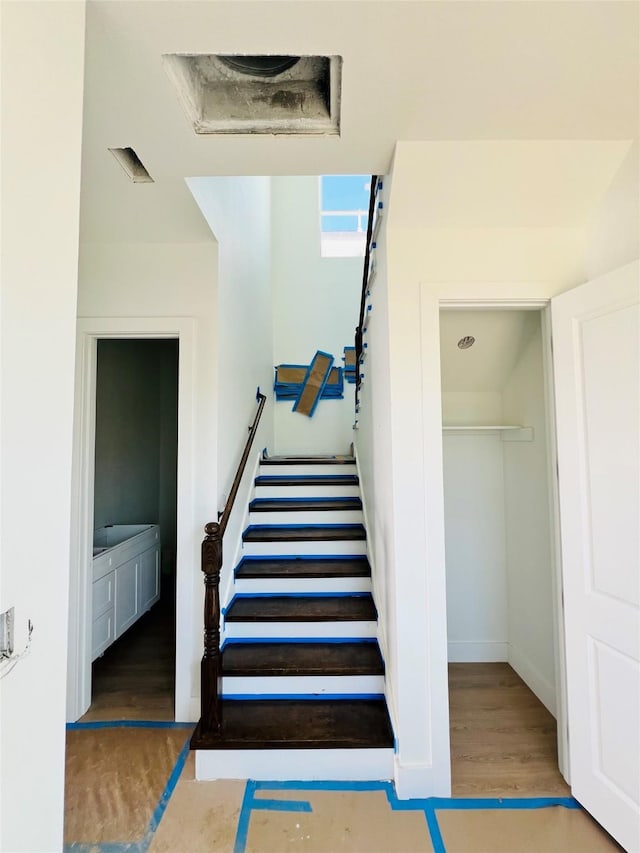 stairs featuring hardwood / wood-style floors