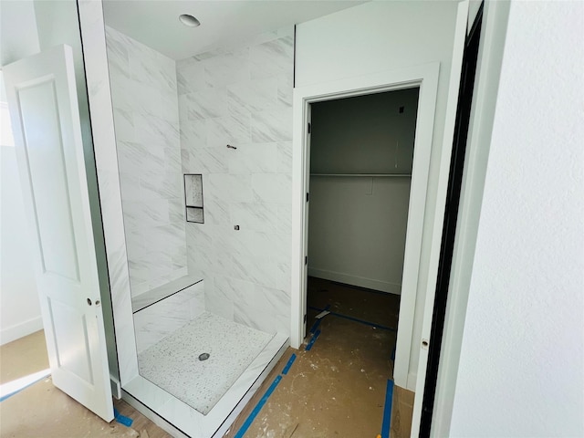 bathroom with a tile shower