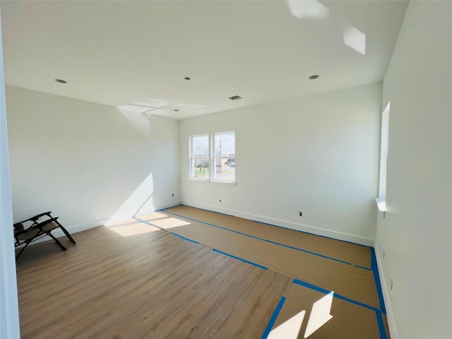 empty room with hardwood / wood-style flooring