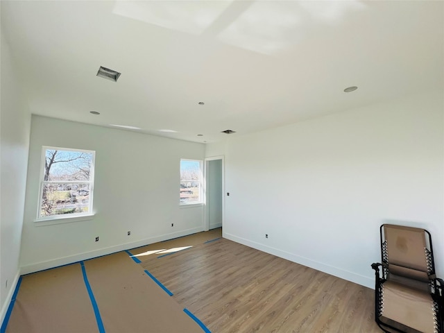 unfurnished room with light wood-type flooring