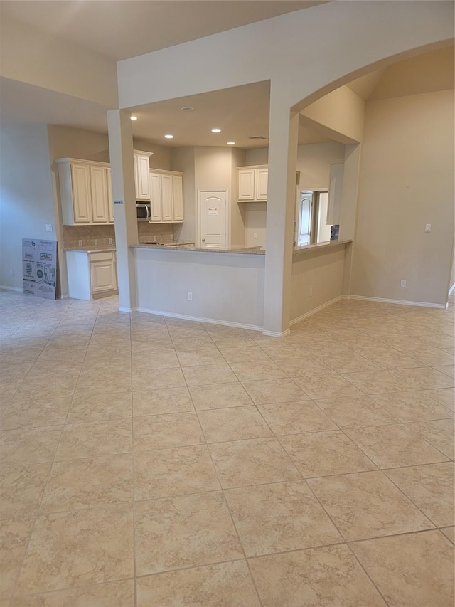 unfurnished living room featuring light tile patterned flooring