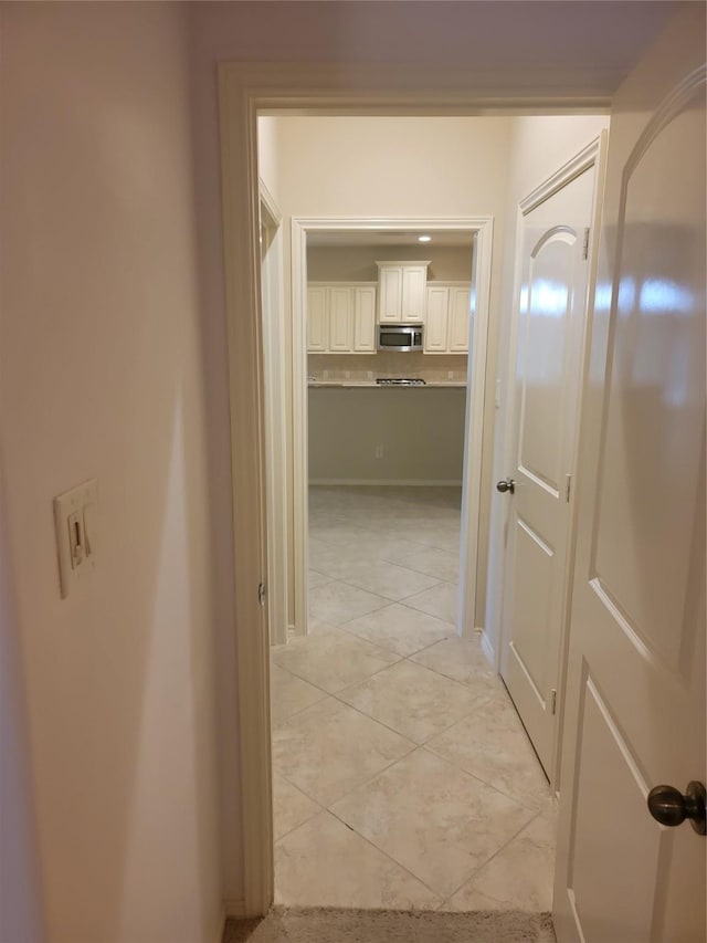 hallway with light tile patterned floors