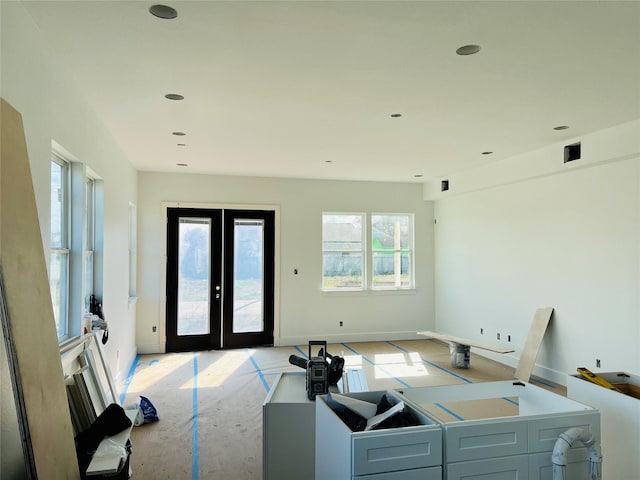 living room featuring plenty of natural light and french doors