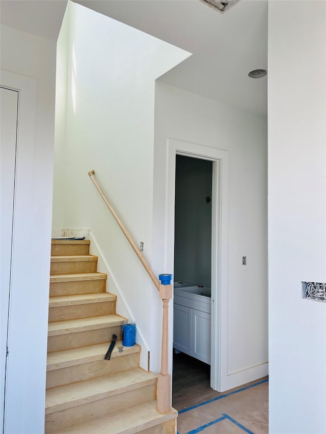 stairway with hardwood / wood-style floors