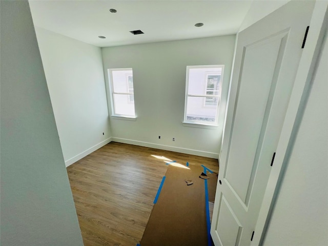 unfurnished room featuring hardwood / wood-style flooring