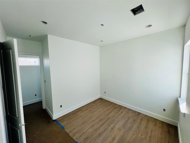 unfurnished room with dark hardwood / wood-style floors