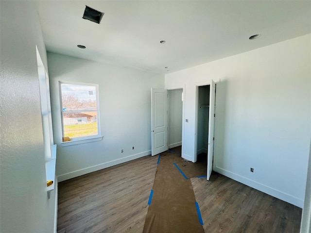 unfurnished bedroom featuring dark hardwood / wood-style flooring