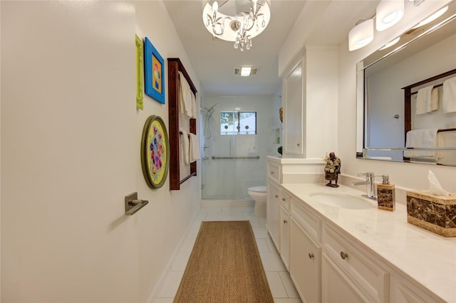 bathroom with a shower with door, tile patterned flooring, an inviting chandelier, vanity, and toilet