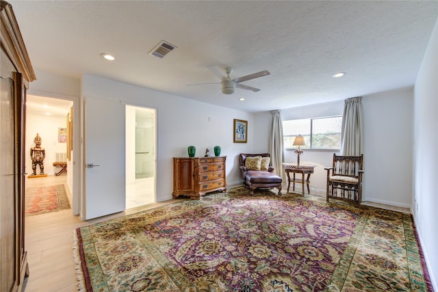 sitting room featuring ceiling fan and a textured ceiling