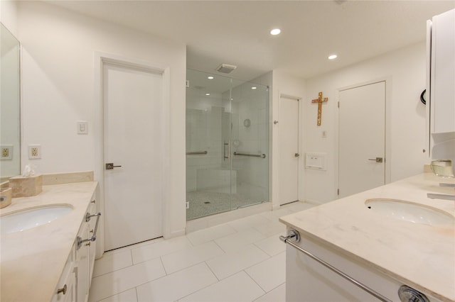 bathroom with vanity, an enclosed shower, and tile patterned floors