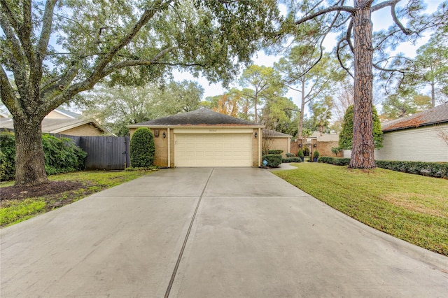 ranch-style home featuring a garage and a front lawn