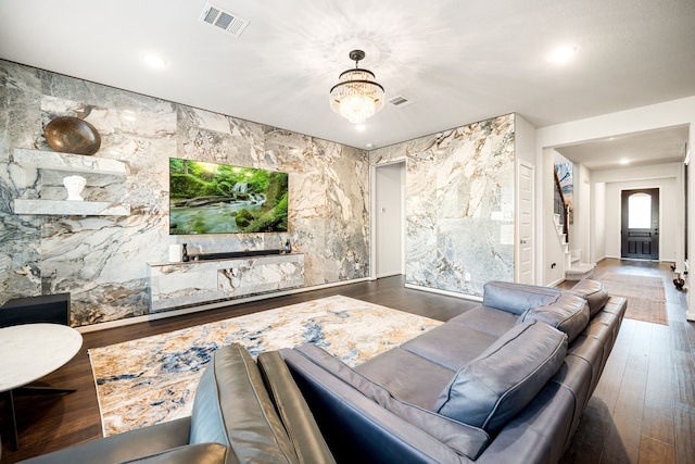 living room featuring dark hardwood / wood-style floors and a chandelier