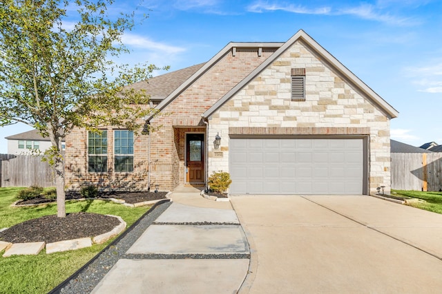 view of front of house with brick siding, fence, driveway, and an attached garage