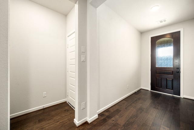 entryway with visible vents, dark wood finished floors, and baseboards