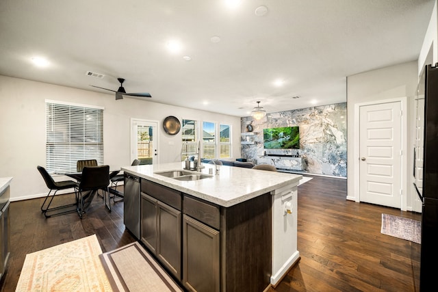 kitchen featuring dark hardwood / wood-style floors, dishwasher, sink, a kitchen island with sink, and dark brown cabinets