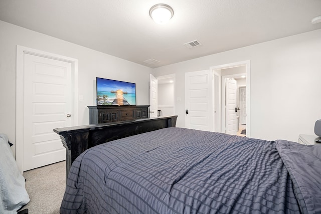 bedroom featuring light carpet and visible vents