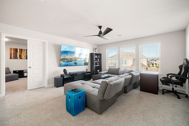 living area with ceiling fan, baseboards, visible vents, and light colored carpet