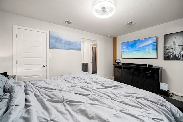 bedroom featuring visible vents and baseboards