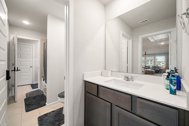 full bathroom featuring washtub / shower combination, vanity, toilet, and tile patterned flooring