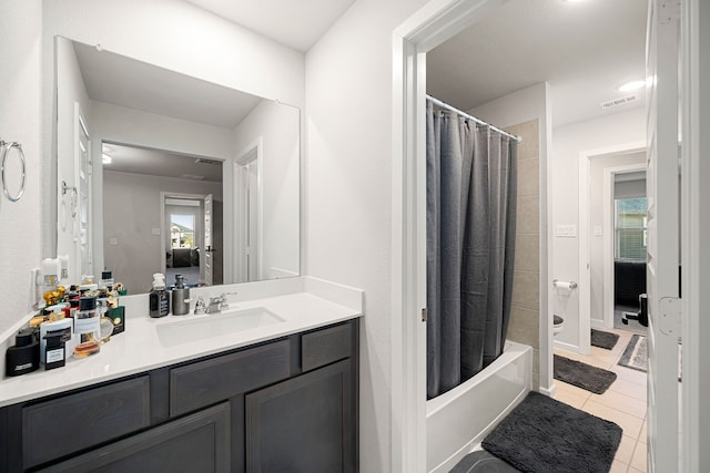 ensuite bathroom with ensuite bathroom, tile patterned flooring, vanity, visible vents, and shower / tub combo with curtain