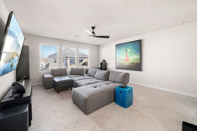 living room with visible vents, baseboards, a ceiling fan, and light colored carpet