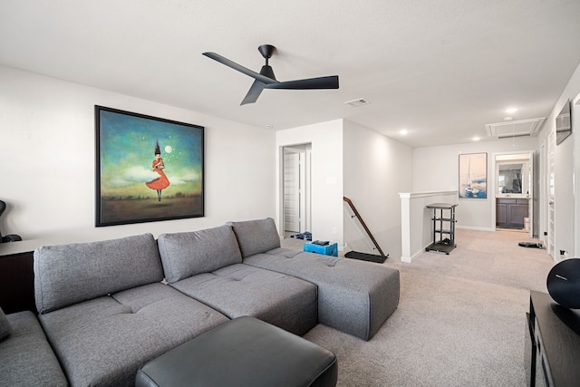 living area with attic access, visible vents, baseboards, a ceiling fan, and light colored carpet