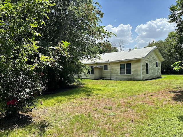 back of property featuring a lawn