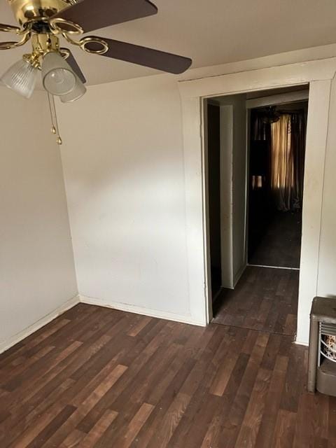 spare room featuring dark hardwood / wood-style flooring and ceiling fan