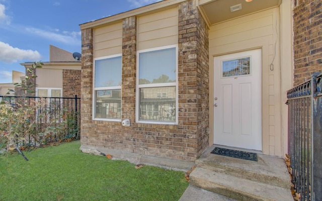 property entrance with a yard