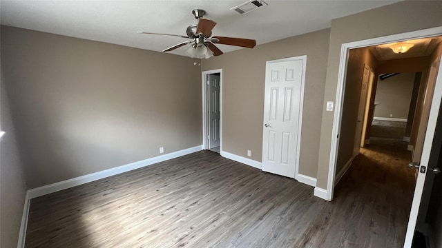 unfurnished bedroom with dark hardwood / wood-style floors and ceiling fan